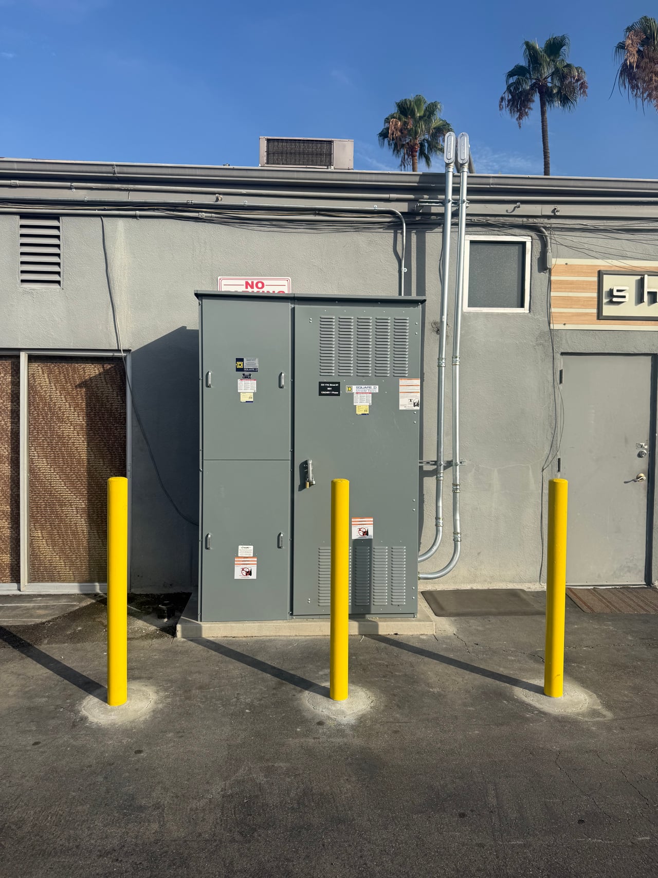New outdoor switchboard with yellow protective posts at 333 17th Street in Costa Mesa