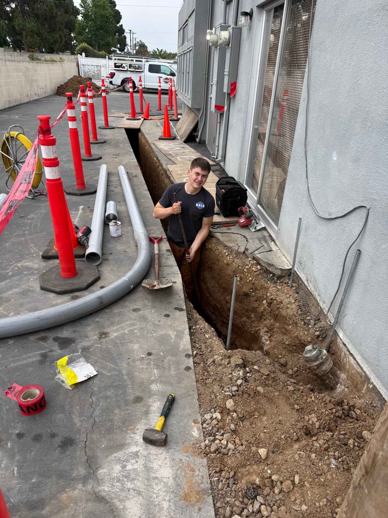 Halo Electric team member in a trench beside electrical conduit at 333 17th Street
