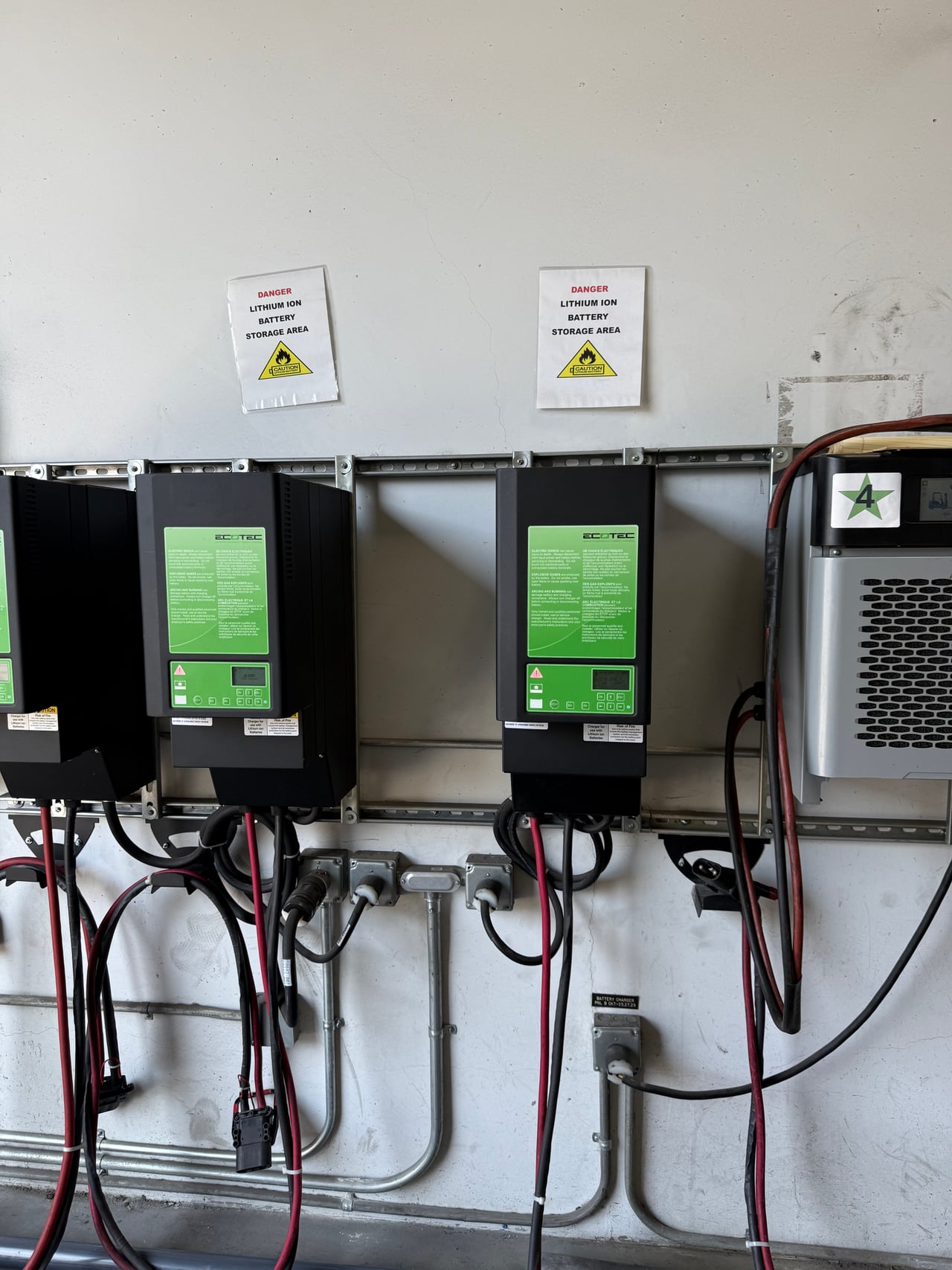 Wall-mounted commercial forklift battery chargers and electrical connections at Cristys in Anaheim