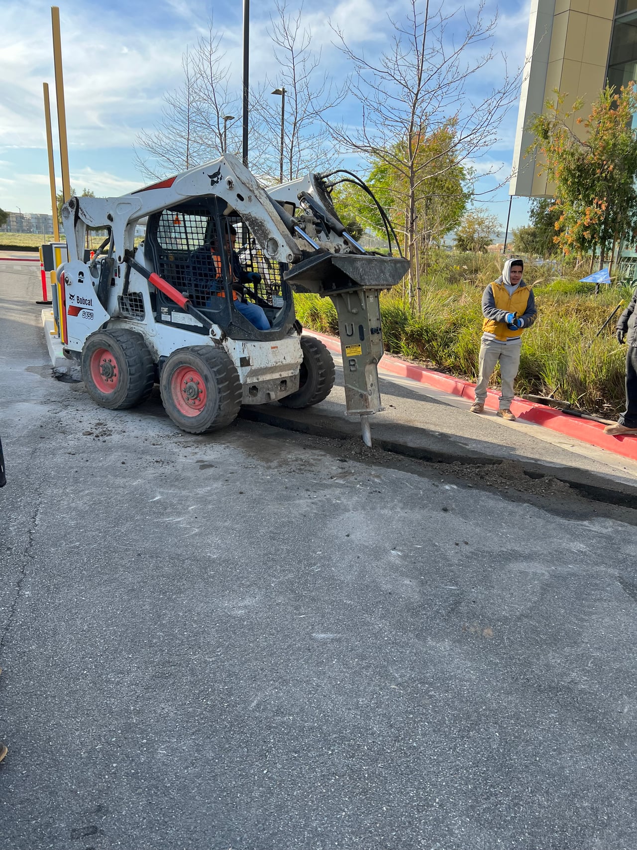 Crew opening pavement for charging-system expansion work at Flight in Tustin
