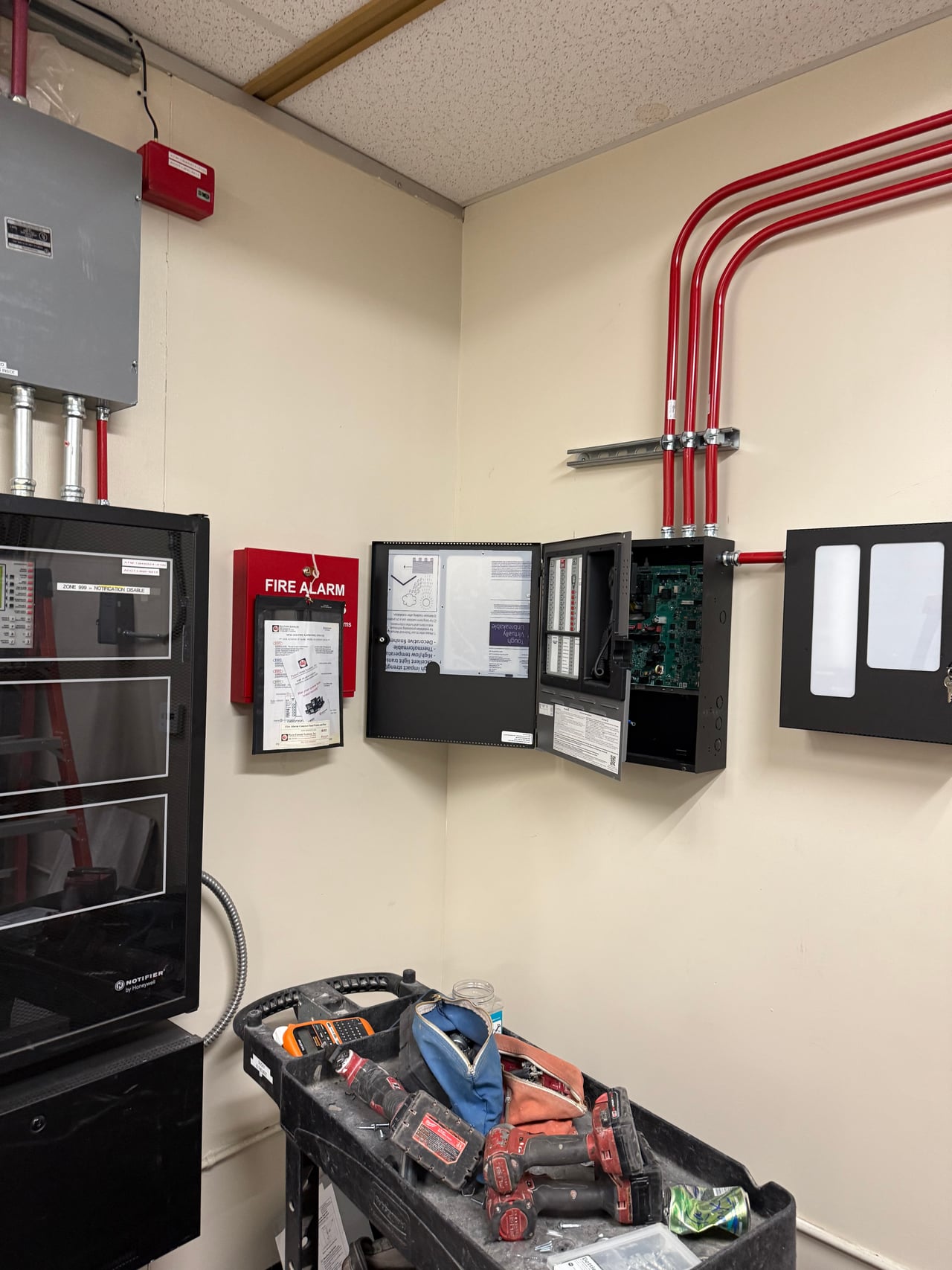 Fire alarm equipment and red conduit at Fremont Elementary