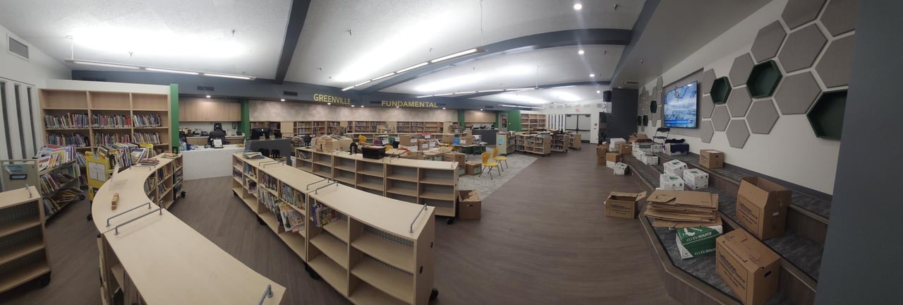 Lighting above bookshelves and reading areas in the Greenville Elementary library