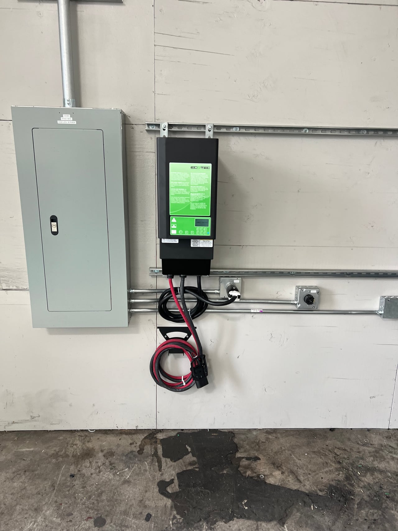 Commercial forklift charger beside an electrical panel at Mainline Sales in Anaheim