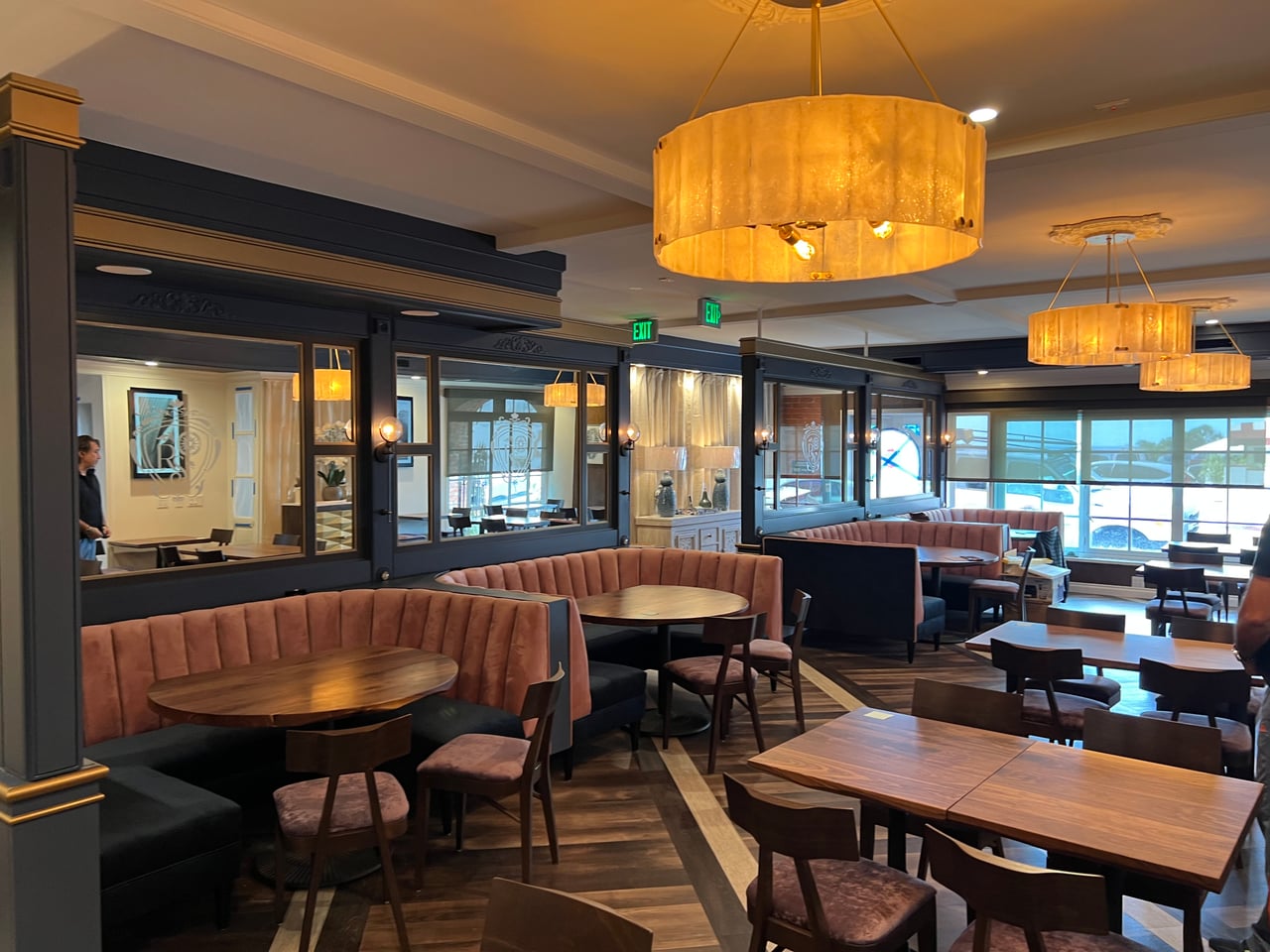 Glowing drum pendants above dining tables and booths at Rum Social